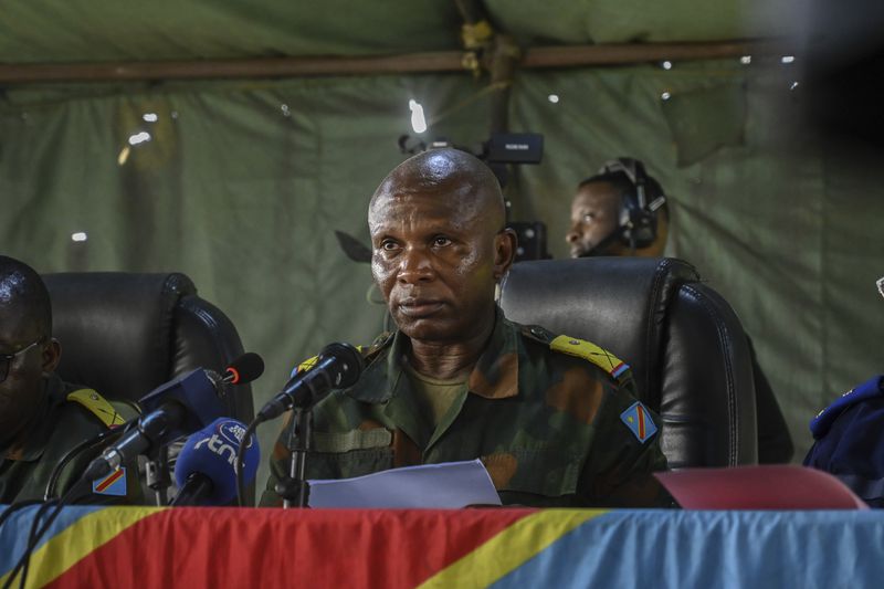 Major Freddy Ehume presides the military court where Three Americans and 50 other defendants are heard in Kinshasa with 52 other defendants Friday June 7, 2024, accused of a role in last month's attempted coup in Congo led by little-known opposition figure Christian Malanga in which six people were killed. (AP Photo/Samy Ntumba Shambuyi)