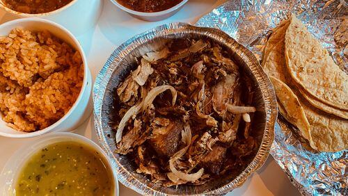 The carnitas dinner for two from Taqueria el Tesoro includes twice-cooked pork carnitas, choice of beans, rice, tortillas, and chips and salsa. Bob Townsend for The AJC