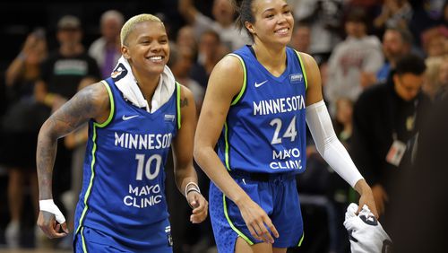 Minnesota Lynx guard Courtney Williams (10) and forward Napheesa Collier (24) celebrate after a win over the Chicago Sky in a WNBA basketball game Friday, Sept. 13, 2024, in Minneapolis. (AP Photo/Bruce Kluckhohn)