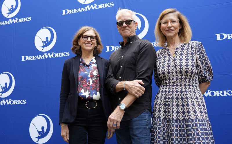 Margie Cohn, left, president of DreamWorks Animation, Chris Sanders, center, director of "The Wild Robot," and Kristin Lowe, chief creative officer of features, pose together during a DreamWorks Animation campus celebration of the film's release, Wednesday, Sept. 25, 2024, in Glendale, Calif. (AP Photo/Chris Pizzello)