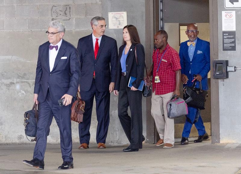 Georgia Secretary of State Brad Raffensperger (second from left) leaves Federal Court in Atlanta after testifying on Monday, Aug. 28, 2023.  (Miguel Martinez / Miguel.Martinezjimenez@ajc.com)