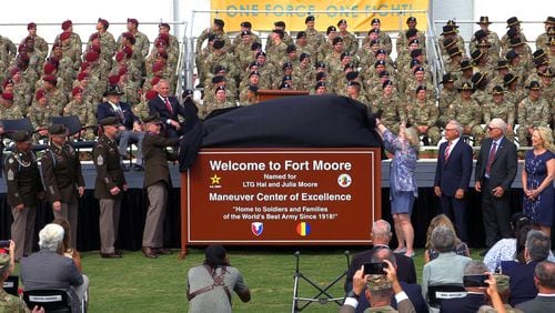 The children of  Lt. Gen. Hal and Julia Moore join the command team at what's now Fort Moore in unveiling the new sign. Fort Benning was redesignated as Fort Moore during a ceremony Thursday morning at Doughboy Stadium. (Photo Courtesy of Mike Haskey/The Ledger-Enquirer)