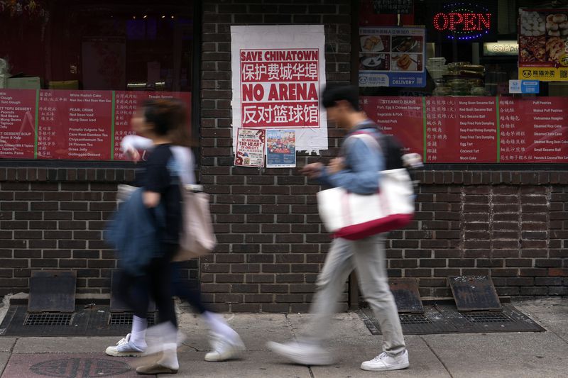 People walk through the Chinatown neighborhood of Philadelphia, Wednesday, Sept. 18, 2024. (AP Photo/Matt Slocum)