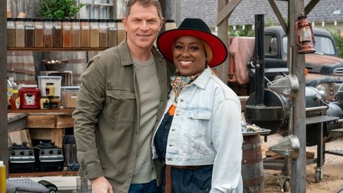 Chef Erica Barrett (r.) wins Master of Que crown on season five of the Food Network cooking competition series 'BBQ Brawl' created by restaurateur and television personality Bobby Flay (l.)