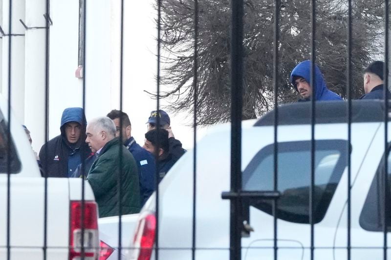 Police escort French rugby players Oscar Jegou, left, and Hugo Auradou, right, in Buenos Aires, Argentina, Thursday, July 11, 2024. The players were arrested following a complaint for sexual assault filed against them after France played Argentina in a test rugby match in Mendoza on July 6. (AP Photo/Natacha Pisarenko)