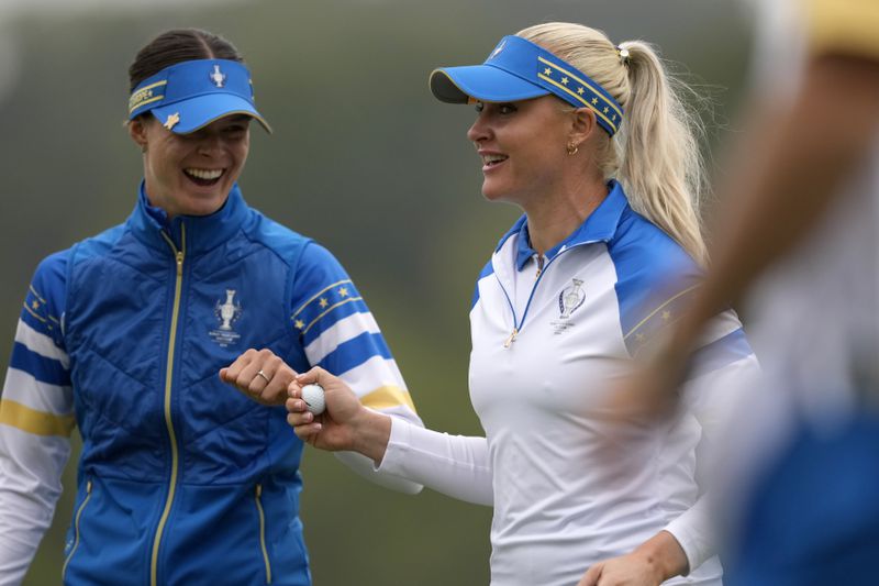 Europe's Charley Hull, right, is congratulated by Linn Grant after making a putt on the 10th hole during a Solheim Cup golf tournament foursomes match at Robert Trent Jones Golf Club, Friday, Sept. 13, 2024, in Gainesville, VA. (AP Photo/Matt York)