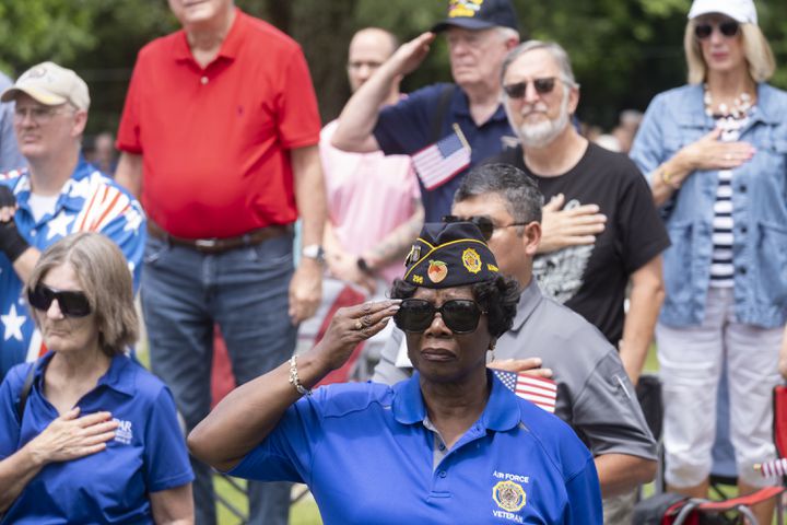 Linda Monroe, who served in the Air Force for 16.5 years, salutes during the playing of the National Anthem while attending the Memorial Day ceremony at Marietta National Cemetery on Monday, May 27, 2024. (Ben Gray / Ben@BenGray.com)