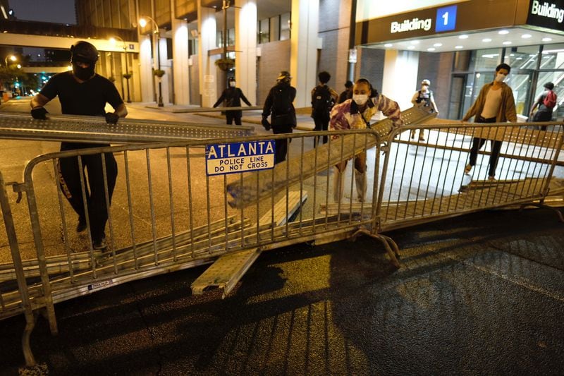 Protesters and police face off in downtown Atlanta Tuesday evening.