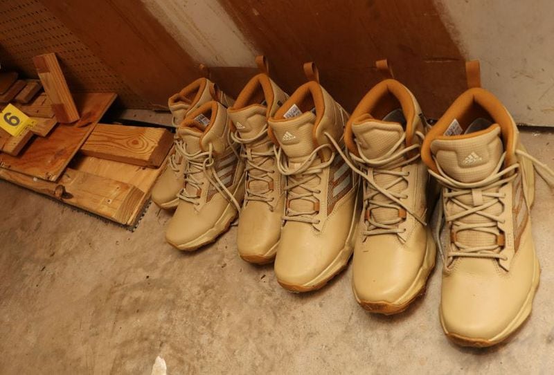 A photo released by Gwinnett County police shows boots and wood lined up in a basement, where investigators believe a woman was killed.