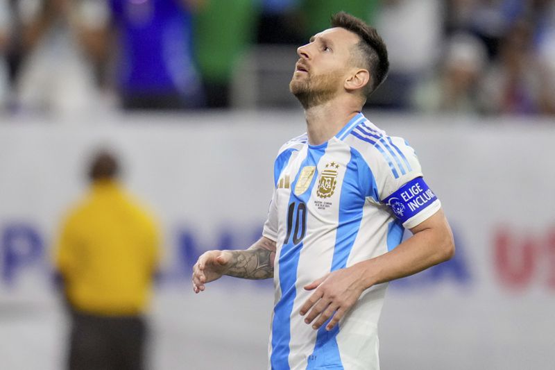 Argentina's Lionel Messi looks up after missing to score in a penalty shootout against Ecuador in a Copa America quarterfinal soccer match in Houston, Thursday, July 4, 2024. (AP Photo/Julio Cortez)