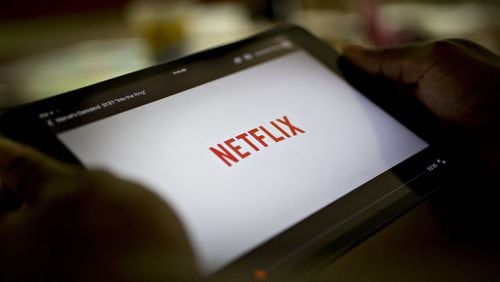 The Netflix app is displayed for a photograph on an Apple iPad. Georgia legislators are considering whether to impose a 4 percent tax on streaming video, downloaded media and other communication services. Bloomberg photo by Daniel Acker