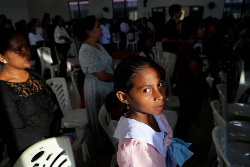 A girl attends Sunday mass at a church In Dili, East Timor, Sunday, Aug. 11, 2024. (AP Photo/Achmad Ibrahim)