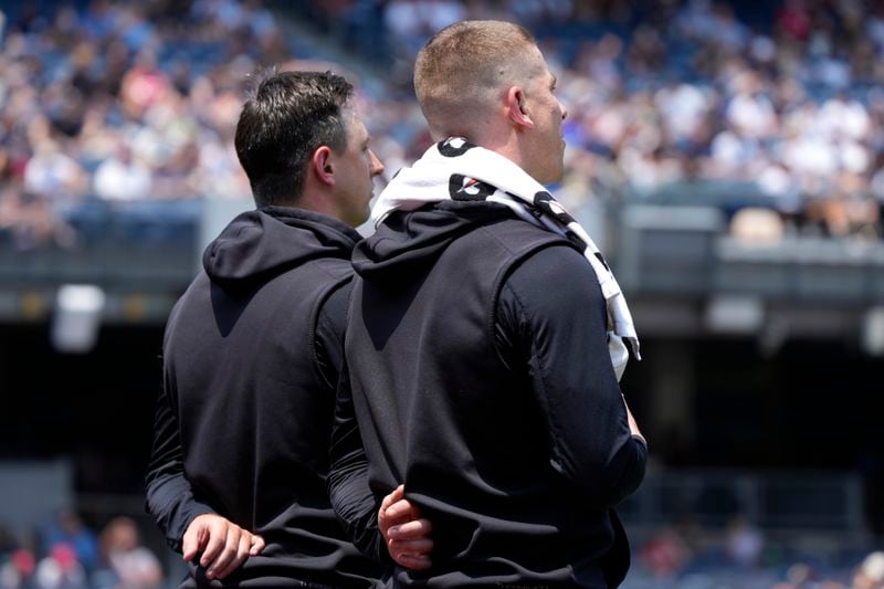 New York Yankees' Cody Poteet, left, and Ian Hamilton, right, stand after the national anthem before the first inning of a baseball game against the Cincinnati Reds, Thursday, July 4, 2024, in New York. (AP Photo/Pamela Smith)