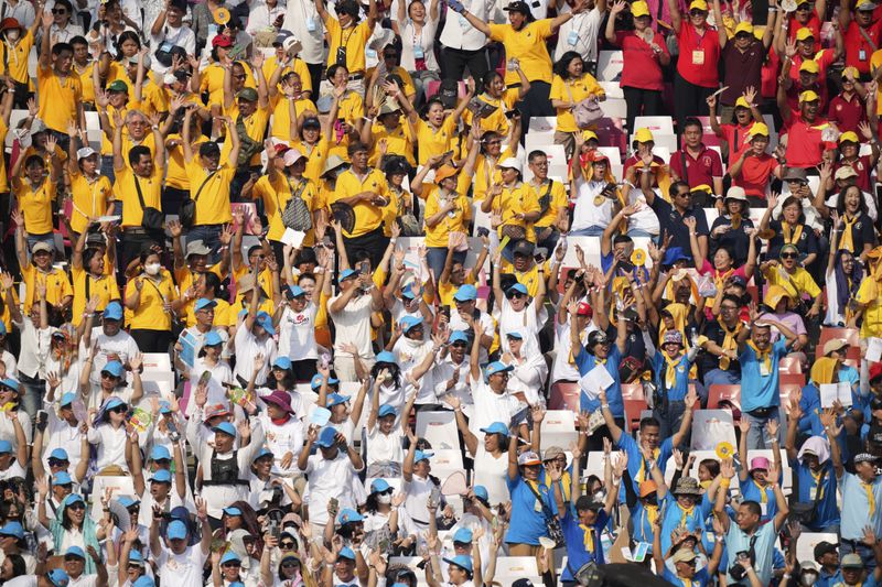 People cheer as they fill the stands ahead of the holy mass to be led by Pope Francis at Gelora Bung Karno Stadium in Jakarta, Indonesia, Thursday, Sept. 5, 2024. (AP Photo/Dita Alangkara, Pool)