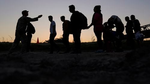 FILE - Migrants who crossed the Rio Grande and entered the U.S. from Mexico are lined up for processing by U.S. Customs and Border Protection, Sept. 23, 2023, in Eagle Pass, Texas. U.S. authorities say border arrests during July have plummeted to a new low for Joe Biden’s presidency, raising prospects that a temporary ban on asylum may be lifted soon. The Border Patrol is expected to arrest migrants about 57,000 times during the month, down about 30% from June and the lowest tally since September 2020, when COVID-19 slowed movement across many borders. (AP Photo/Eric Gay, File)