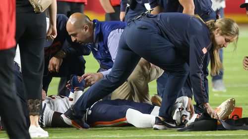 Chicago Bears safety Douglas Coleman III, bottom, is treated on the field after being injured during the second half of a preseason NFL football game against the Kansas City Chiefs, Thursday, Aug. 22, 2024 in Kansas City, Mo. (AP Photo/Reed Hoffmann)