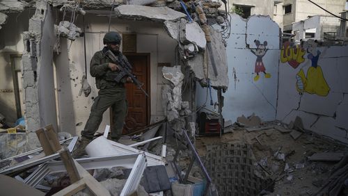 An Israeli soldier stands at the entrance of a tunnel where the military says six Israeli hostages were recently killed by Hamas militants in the southern Gaza Strip on Friday, Sept. 13, 2024. (AP Photo/Leo Correa)