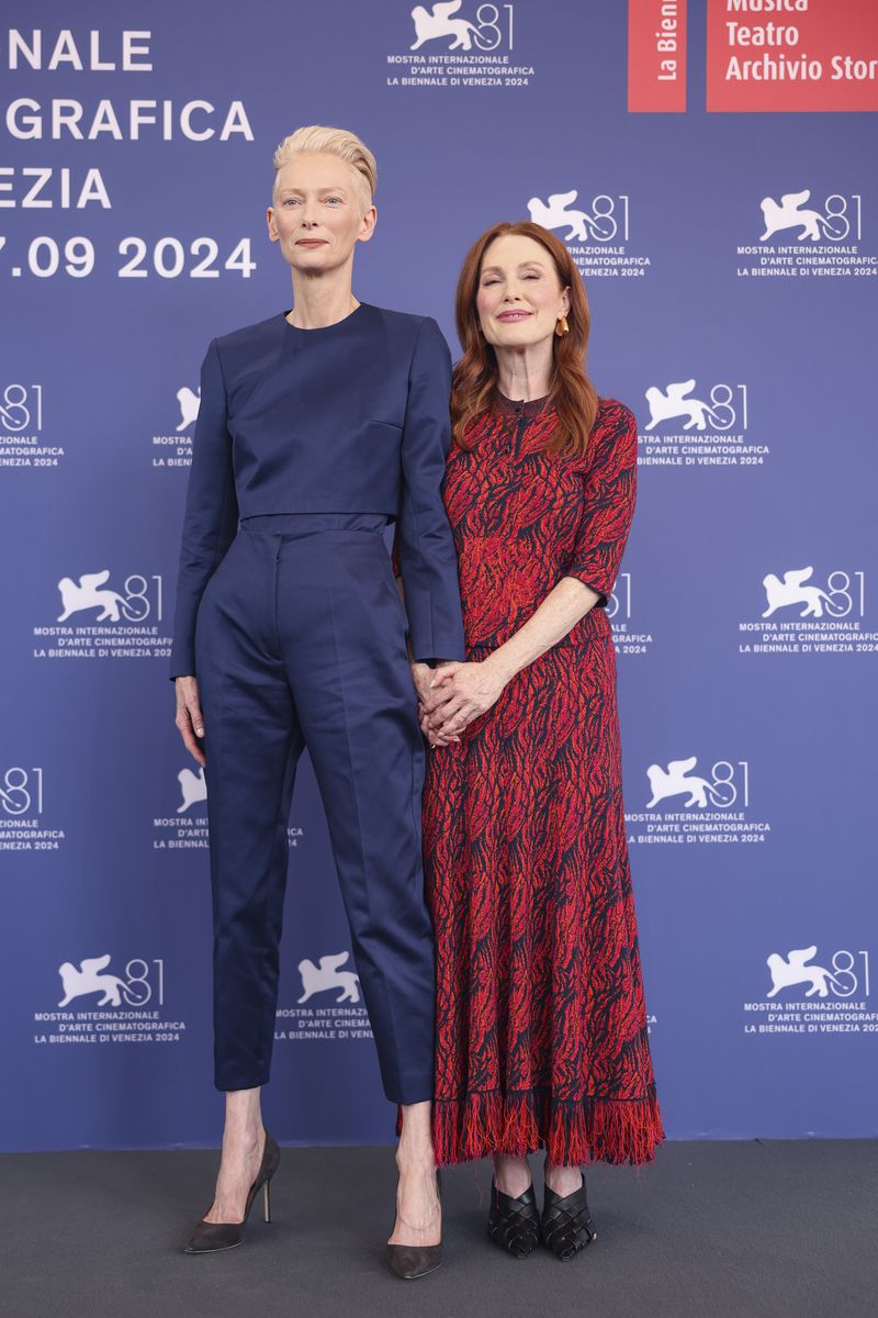 Tilda Swinton, left, and Julianne Moore pose for photographers at the photo call for the film 'The Room Next Door' during the 81st edition of the Venice Film Festival in Venice, Italy, on Monday, Sept. 2, 2024. (Photo by Vianney Le Caer/Invision/AP)