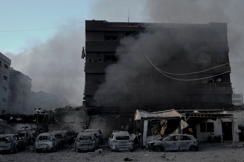 Smoke rises near charred cars at the site of an Israeli airstrike in Dahiyeh, Beirut, Lebanon, Sunday, Oct. 6, 2024. (AP Photo/Bilal Hussein)