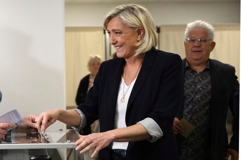 French far-right leader Marine Le Pen casts her ballot to vote for the European election, Sunday, June 9, 2024 in Henin-Beaumont, northern France. Polling stations opened across Europe on Sunday as voters from 20 countries cast ballots in elections that are expected to shift the European Union's parliament to the right and could reshape the future direction of the world's biggest trading bloc. (AP Photo/Aurelien Morissard)