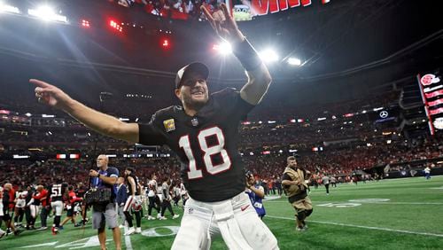 Atlanta Falcons quarterback Kirk Cousins (18) celebrates with the fans after the team defeated the Tampa Bay Buccaneers during overtime in an NFL football game Thursday, Oct. 3, 2024, in Atlanta. (AP Photo/Butch Dill)