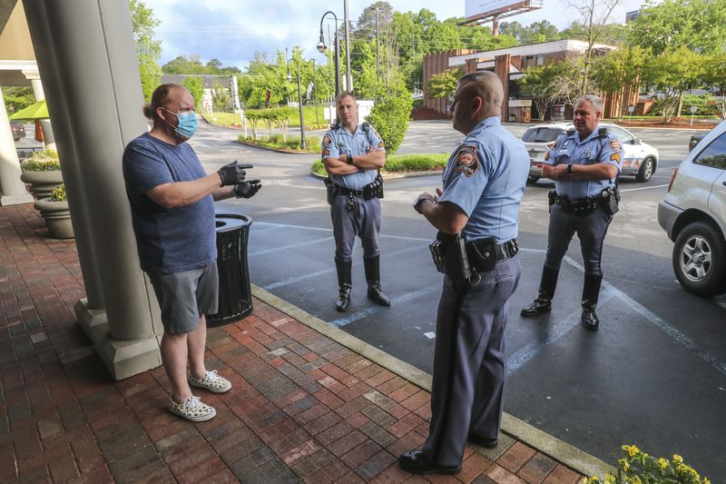 April 24, 2020 Atlanta: Barber and owner of Chris Edwards wears a mask (left) as he talks with GSP Troopers who were responding to a complaint call that there was a crowd gathering at the shop at Peachtree Battle Barber Shop at 2333 Peachtree Road in Atlanta on Friday, April 24, 2020. The Troopers found the business in compliance. The first phase of Gov. Brian KempÃ¢â¬â¢s plan to reopen Georgia during the coronavirus pandemic included haircut shops and gyms, though not all chose to open their doors. At Peachtree Battle Barber Shop in Buckhead, customers waited in line shortly after 7 a.m., Channel 2 Action News reported. Matt Maddox was one of those customers later Friday morning. Ã¢â¬ÅI certainly donÃ¢â¬â¢t want to spread it to anyone so IÃ¢â¬â¢ve got a mask, but IÃ¢â¬â¢m not really concerned,Ã¢â¬Â Maddox said. Ã¢â¬ÅIf youÃ¢â¬â¢re cutting hair or youÃ¢â¬â¢re a waiter, you havenÃ¢â¬â¢t been working, so it helps get the economy started again.Ã¢â¬Â JOHN SPINK/JSPINK@AJC.COM