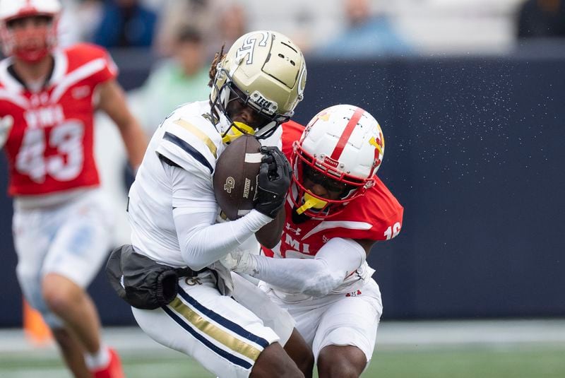 Georgia Tech wide receiver Eric Singleton Jr. (2) makes a catch as Virginia Military Institute cornerback Asa Locks (16) defends during the first half of a NCAA college football game Sunday, Sept. 14, 2024, in Atlanta,. (AP Photo/John Bazemore)