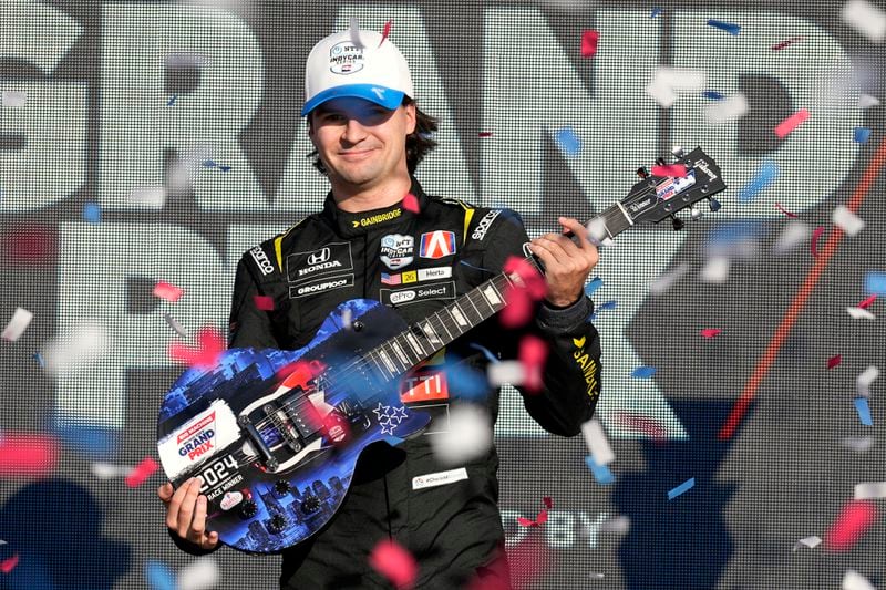 Colton Herta holds his guitar trophy after winning an IndyCar auto race Sunday, Sept. 15, 2024, at Nashville Superspeedway in Lebanon, Tenn. (AP Photo/Mark Humphrey)