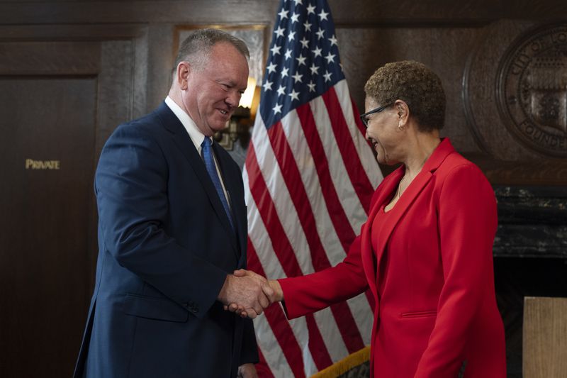 Los Angeles Mayor Karen Bass, right, and newly appointed police chief Jim McDonnell shake hands during a news conference in Los Angeles, Friday, Oct. 4, 2024. (AP Photo/Jae C. Hong)