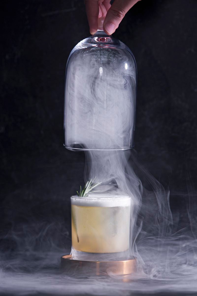 A rosemary & autumn at Atlas is served in a rosemary smoke-filled glass cloche. Courtesy of Tomas Espinoza