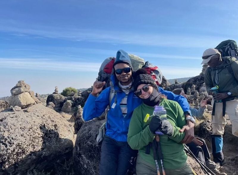 Christy Howard, right, stands for a photo with one of her climbing group's porters, whose nickname was Good Luck. Howard, a 50-year-old Chattanoogan with epilepsy, climbed Mount Kilimanjaro in July. (Contributed photo)