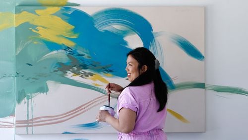 Artist Christina Kwan works on a new painting in her Midtown Atlanta studio. She has recently been experimenting with art that goes beyond canvas.