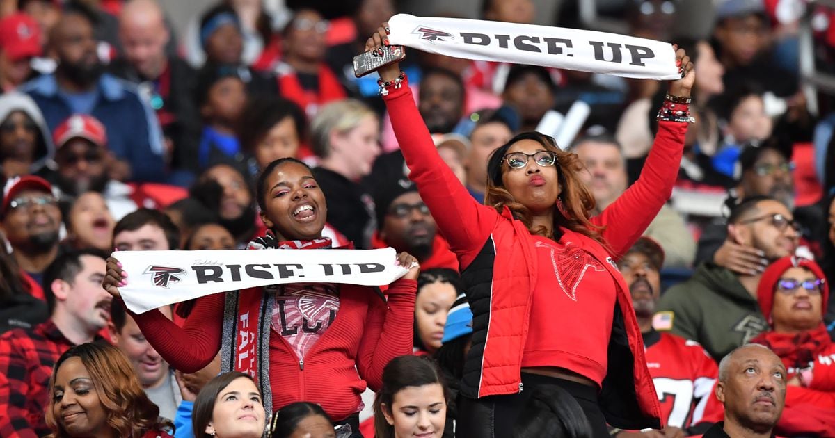 An Atlanta Falcons fans cheers in the first half of an NFL