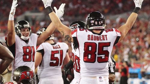 Falcons tight ends Austin Hooper (left) and Eric Saubert signal the touchdown as Levine Toilolo recovers Devonta Freemans fumble into the endzone for a touchdown against the Buccaneers during the first half on the way to a 24-21 victory in a NFL football game on Monday, December 18, 2017, in Tampa.  Curtis Compton/ccompton@ajc.com