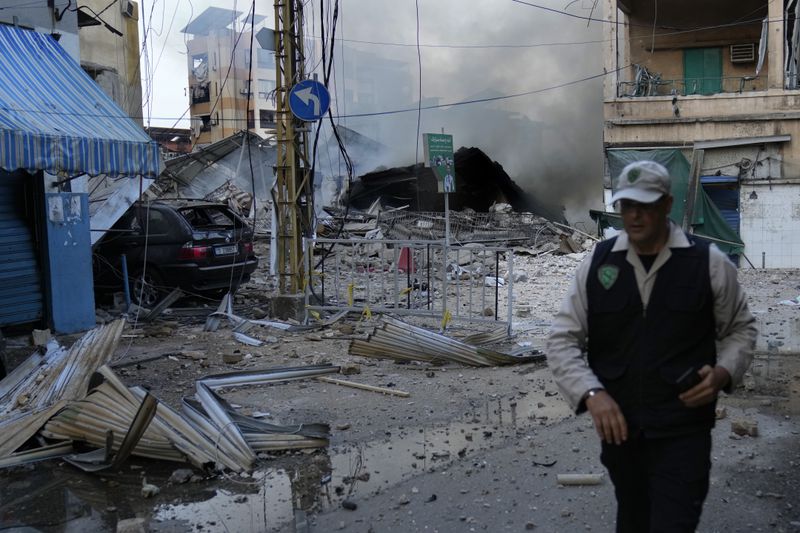 A man leaves a street after he saw the building where he was living and destroyed by Israeli airstrike in Dahiyeh, Beirut, Lebanon, Sunday, Oct. 6, 2024. (AP Photo/Hussein Malla)