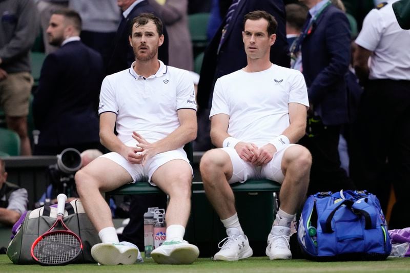 Britain's Andy Murray, right, and brother Jamie Jamie react following their first round doubles match against Australia's John Peers and Ricky Hijikata at the Wimbledon tennis championships in London, Thursday, July 4, 2024. (AP Photo/Kirsty Wigglesworth)