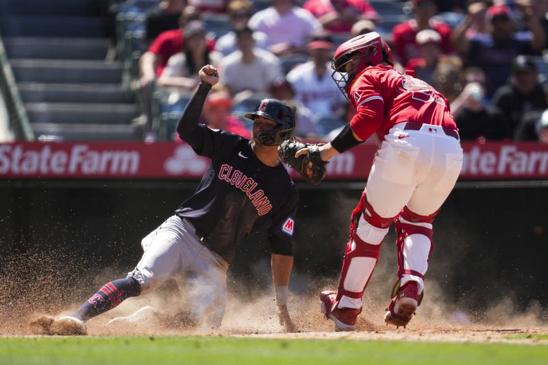 Los Angeles Angels catcher Matt Thaiss, right, tags out Cleveland Guardians' Tyler Freeman at home during the eighth inning of a baseball game in Anaheim, Calif., Sunday, May 26, 2024. (AP Photo/Ashley Landis)