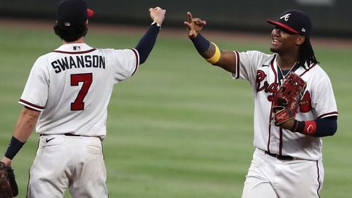 092220 Atlanta: Braves shortstop Dansby Swanson (left) and outfielder Ronald Acuna celebrate clinching their third consecutive National League East championship title following an 11-1 victory over the Miami Marlins Tuesday, Sept. 22, 2020, in Atlanta. (Curtis Compton / Curtis.Compton@ajc.com)