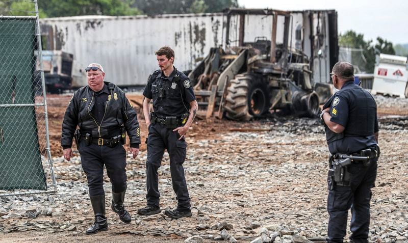 Atlanta police and construction personnel were on the construction site of the police training center Monday morning, March 6, 2023 in Atlanta examining equipment set on fire and destroyed by violent protests Sunday. (John Spink / John.Spink@ajc.com)

