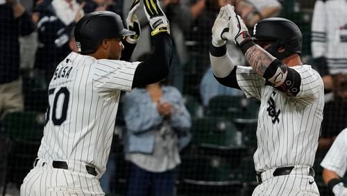 Chicago White Sox's Korey Lee, right, is greeted by Lenyn Sosa, left, after hitting a two-run home run against the Los Angeles Angels during second inning of a baseball game, Wednesday, Sept. 25, 2024, in Chicago. (AP Photo/David Banks)