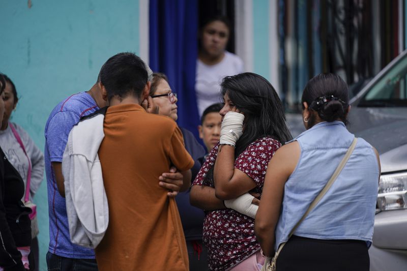 Estrella Bejarano, second from right, the mother of two children who died after a rain-induced landslide, speaks with relatives in Naucalpan, Mexico, Tuesday, Sept. 17, 2024. (AP Photo/Felix Marquez)