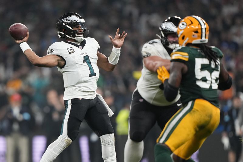 Philadelphia Eagles quarterback Jalen Hurts (1) passes against the Green Bay Packers during the first half of an NFL football game, Friday, Sept. 6, 2024, at the Neo Quimica Arena in Sao Paulo. (AP Photo/Doug Benc)