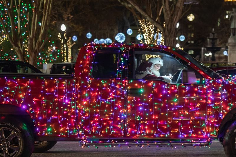 Santa Claus and Mrs. Claus are seen in a decorated truck in Marietta Square. (BRANDEN CAMP FOR THE ATLANTA JOURNAL-CONSTITUTION)