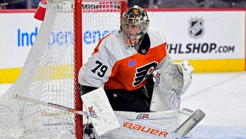 FILE - Philadelphia Flyers' goaltender Carter Hart guards the net during an NHL hockey game against the Colorado Avalanche, Jan. 20, 2024, in Philadelphia. Four current members of the National Hockey League charged with sexual assault in Canada will become free agents after not receiving qualifying offers from their respective teams. Hart was under contract with Philadelphia, Michael McLeod and Cal Foote with New Jersey and Dillon Dube with Calgary when they were charged in connection with an incident that occurred in London, Ontario, in 2018 after they were teammates on Canada's world junior team. (AP Photo/Derik Hamilton, File)