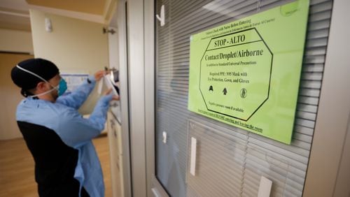 COVID-19 still poses a threat, especially to those who are medically vulnerable, including older adults. A sign advises medical personnel and visitors to take precautions before entering rooms with patients infected with COVID-19 at the Northeast Medical Georgia Center in Gainesville last February. (Miguel Martinez/The Atlanta Journal-Constitution/TNS)