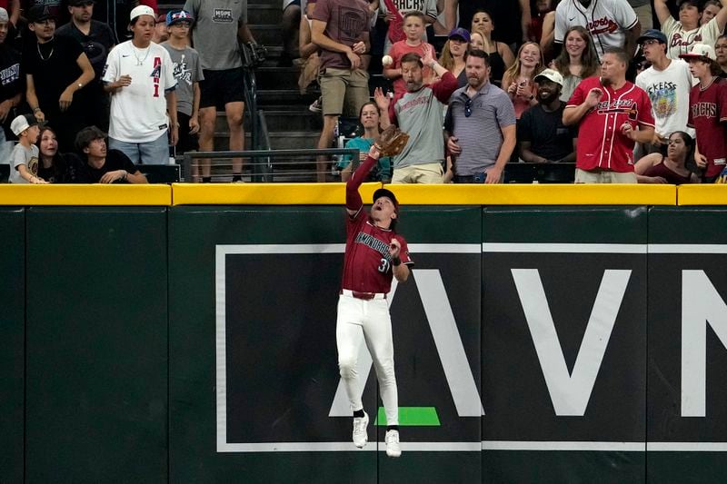 Arizona Diamondbacks' Jake McCarthy catches a fly out hit by Atlanta Braves' Matt Olson during the ninth inning of a baseball game, Thursday, July 11, 2024, in Phoenix. (AP Photo/Matt York)