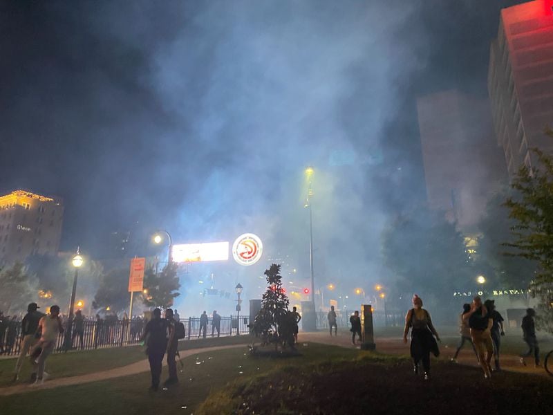 Tear gas is deployed to disperse the crowds in downtown Atlanta Friday night.
