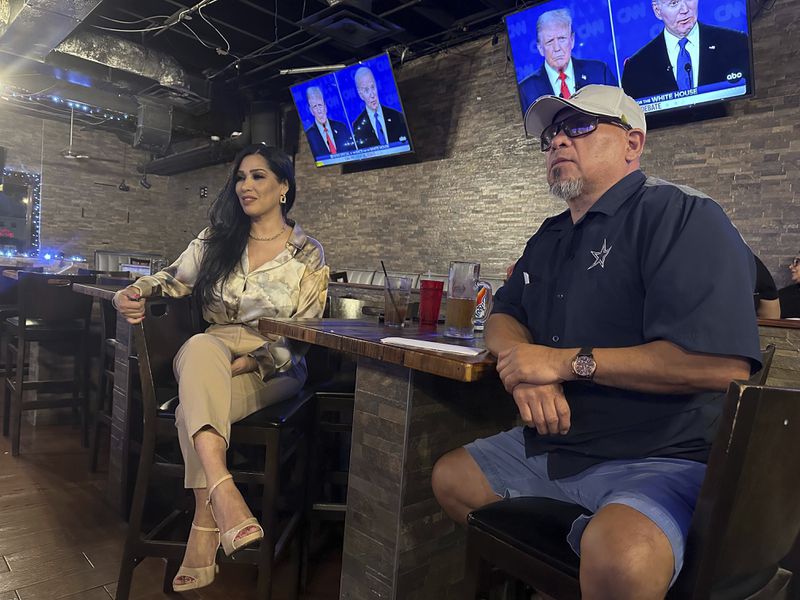 Marco Perez, 53, sits with Virginia López, 51, at a McAllen, Texas bar Thursday June 27, 2024. López is unsure which way she's voting. "Unfortunately I feel that this is the first time where I don't even know who I want to vote for," Virginia Lopez said. "I really feel that one of them, the Republican, I'm disappointed with what he's done, with his behavior. And the other one, I just feel like he's too old." (AP Photo/Valerie Gonzalez)