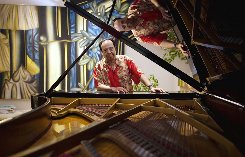 FILE - Bossa Nova piano maestro Sergio Mendes sits for a portrait at his home in Woodland Hills, Calif., on Feb. 7, 2006. (AP Photo/Damian Dovarganes, File)