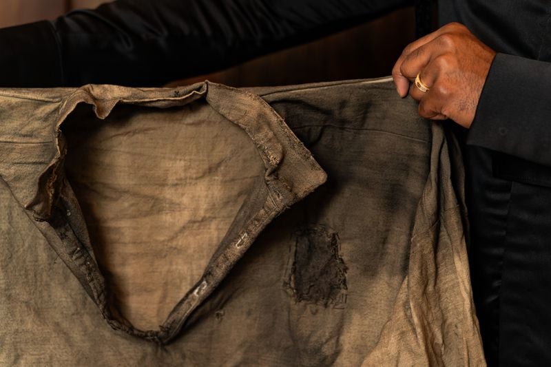 Tailor Carl Ulysses displays a shirt he made worn by Will Smith in “Emancipation” at The 500 Apartments in Atlanta on Friday, June 28, 2024. (Seeger Gray / AJC)